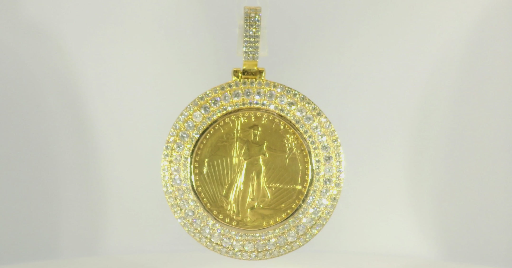 Elegant gold pendant featuring a detailed coin surrounded by sparkling diamonds, perfect for statement jewelry.